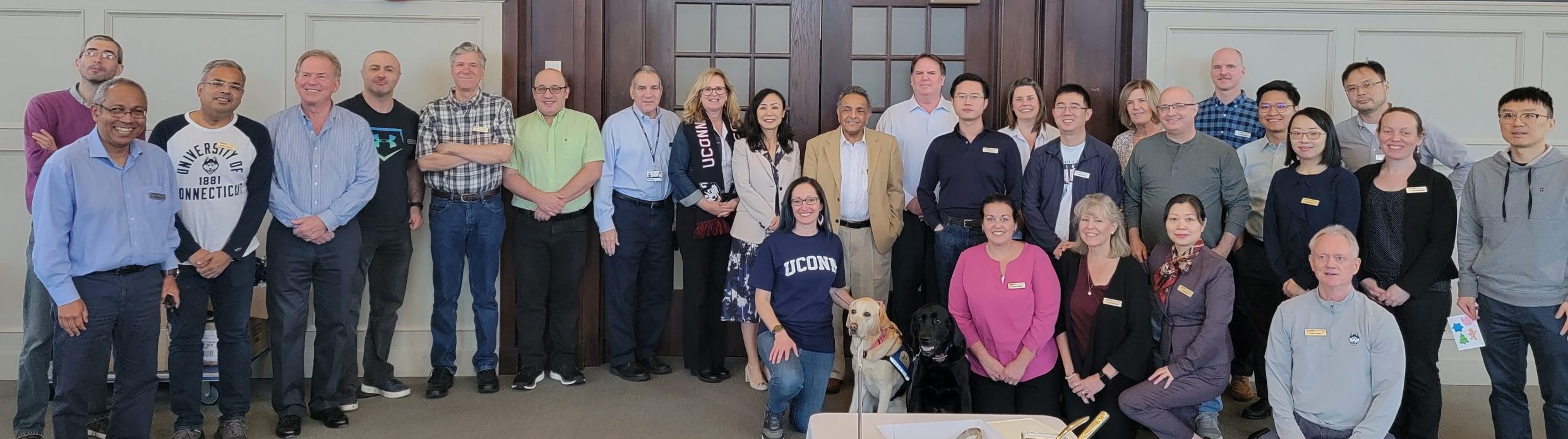 Finance Department Faculty and Staff with Tildy and Carson in the Wilbur Cross Reading Room